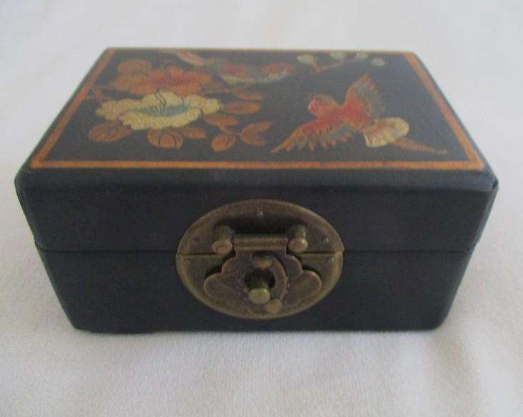 A vintage hand painted oriental "treasure box" with beautiful floral and bird  painted on leather