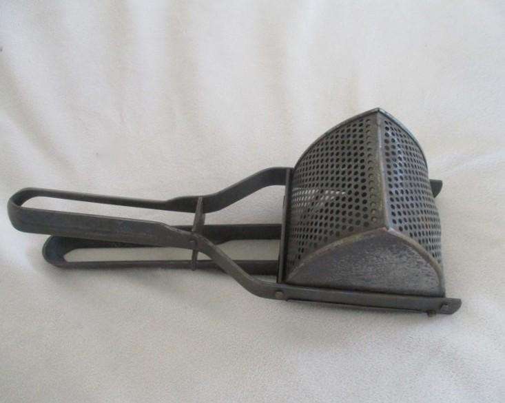 Two vintage potato kitchen utensils - masher and french fry cutter
