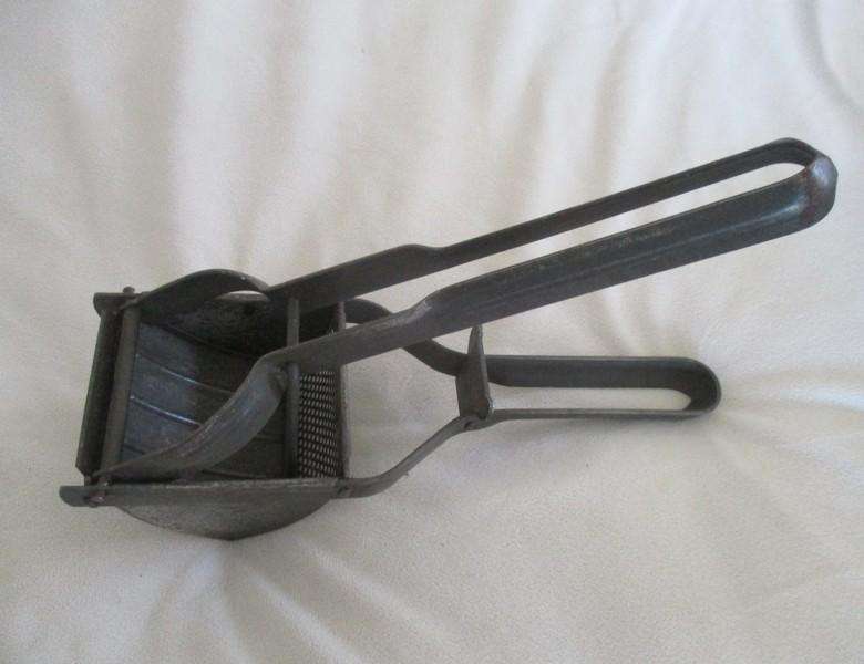 Two vintage potato kitchen utensils - masher and french fry cutter