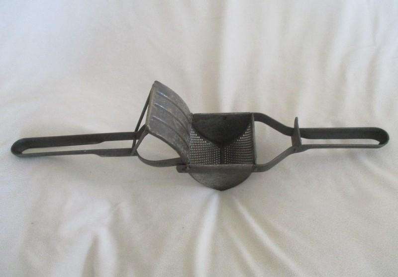 Two vintage potato kitchen utensils - masher and french fry cutter