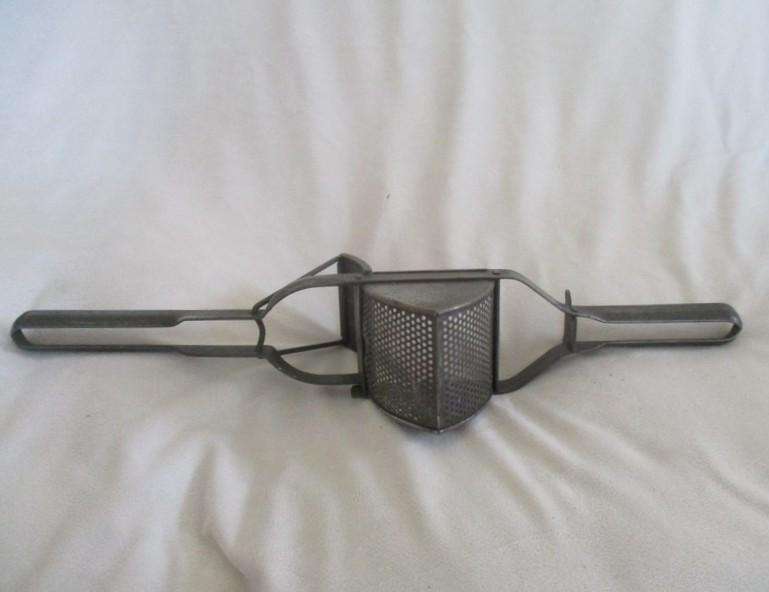 Two vintage potato kitchen utensils - masher and french fry cutter