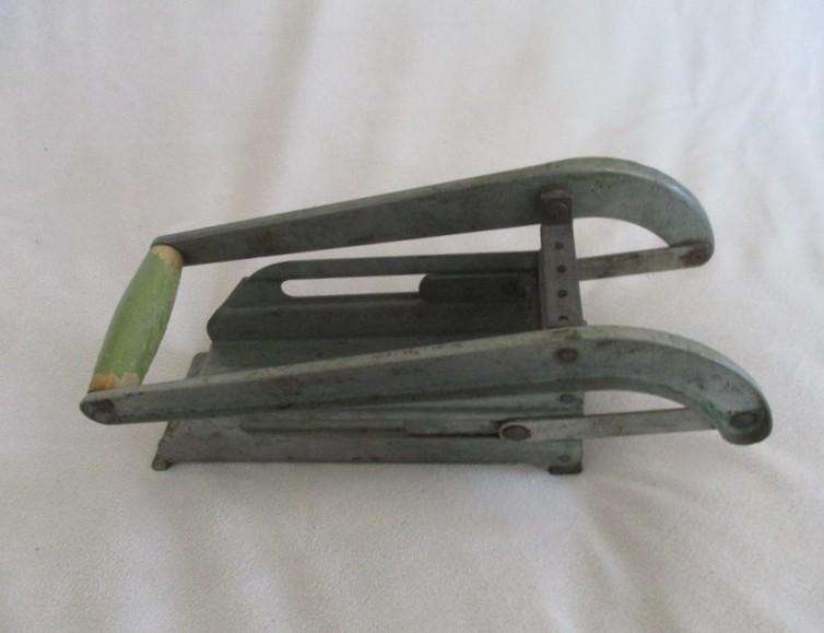 Two vintage potato kitchen utensils - masher and french fry cutter
