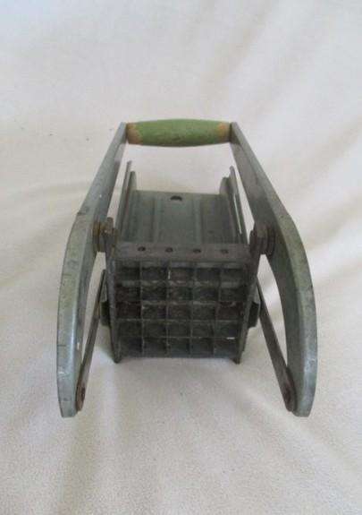 Two vintage potato kitchen utensils - masher and french fry cutter