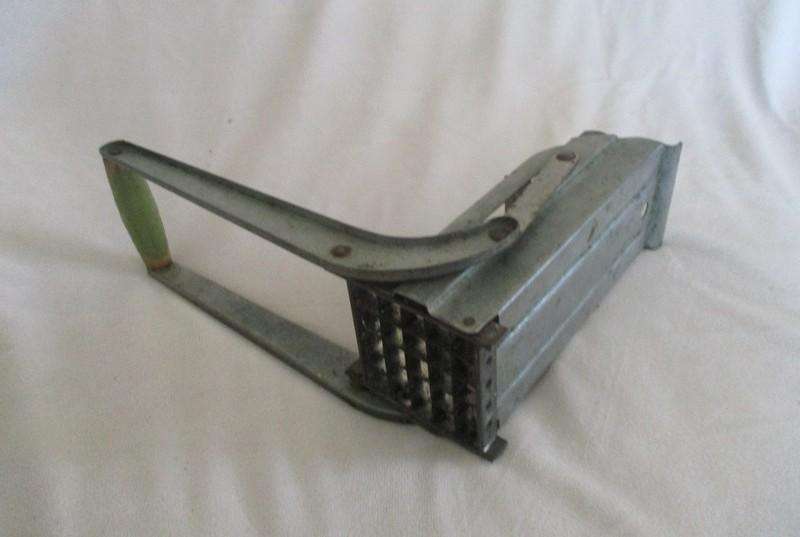 Two vintage potato kitchen utensils - masher and french fry cutter