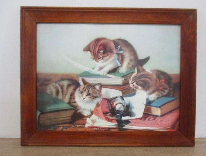 A charming vintage print of three naughty cats framed in wood