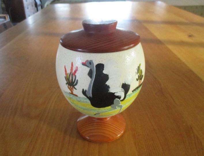 A beautiful satin lined genuine Ostrich egg with solid wood base and lid