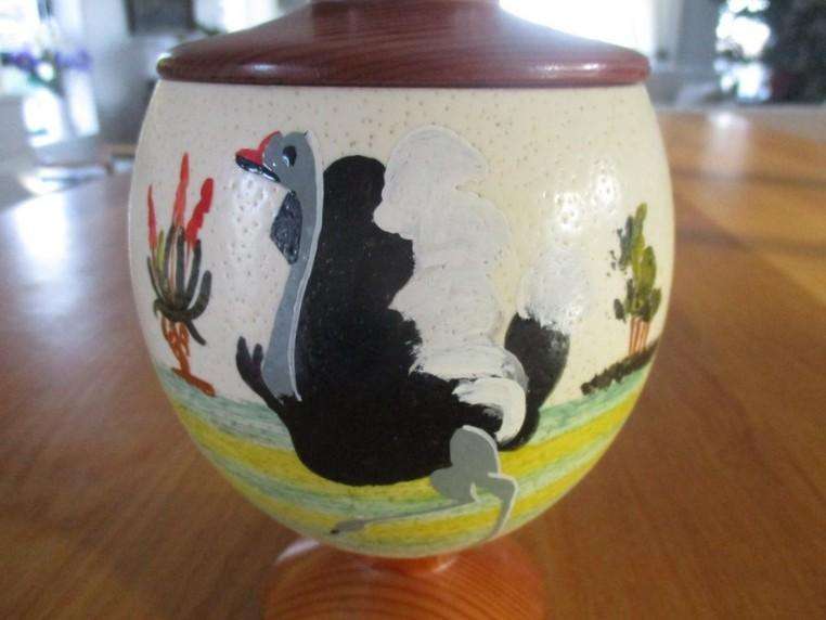 A beautiful satin lined genuine Ostrich egg with solid wood base and lid
