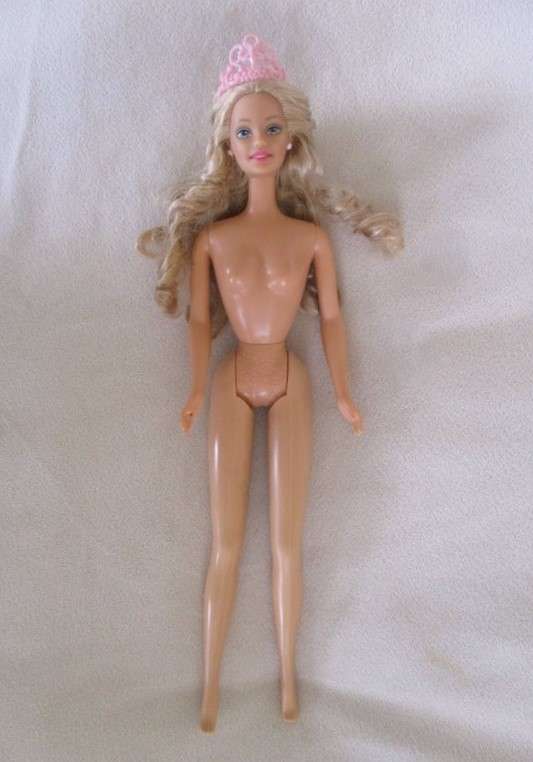 A Mattel Barbie with soft, curly hair with knees that bend - in pretty dress