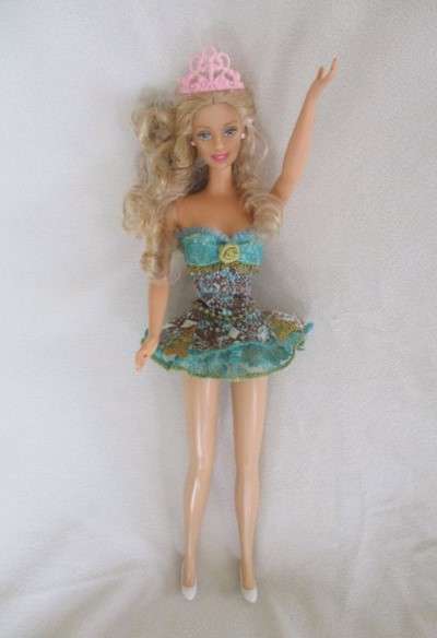 A Mattel Barbie with soft, curly hair with knees that bend - in pretty dress