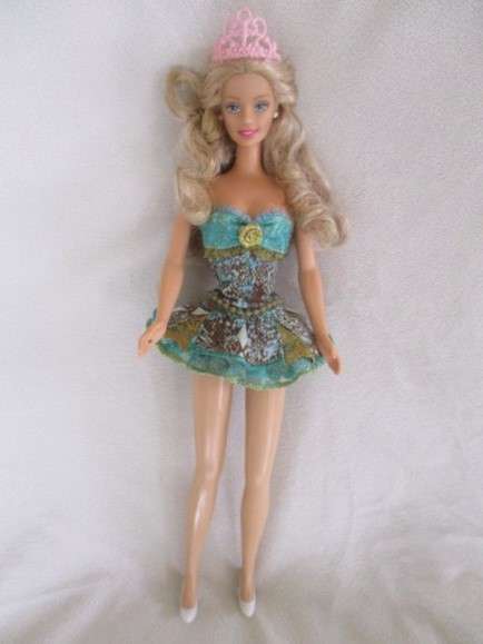 A Mattel Barbie with soft, curly hair with knees that bend - in pretty dress