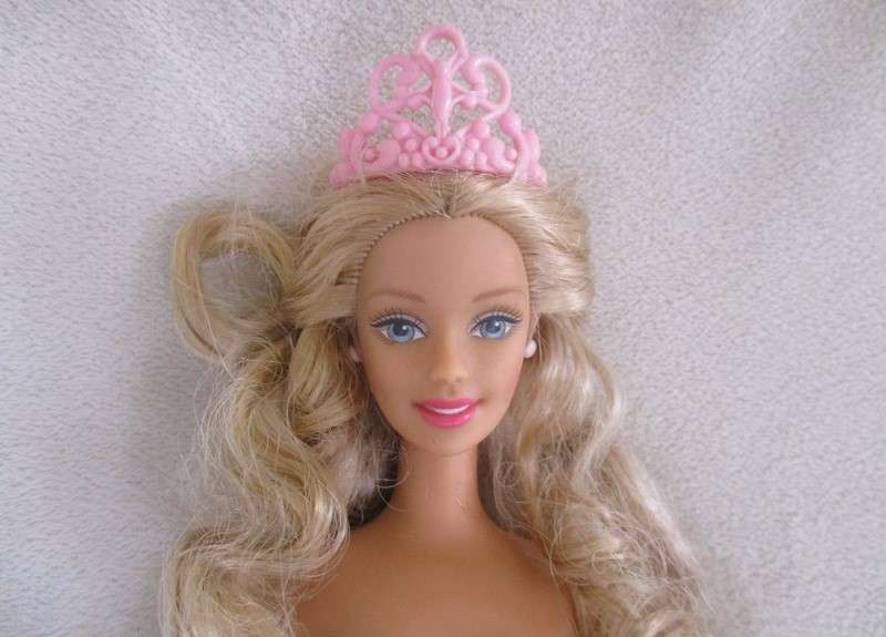 A Mattel Barbie with soft, curly hair with knees that bend - in pretty dress