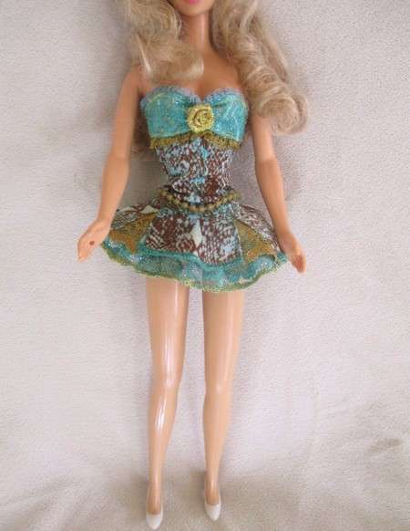 A Mattel Barbie with soft, curly hair with knees that bend - in pretty dress