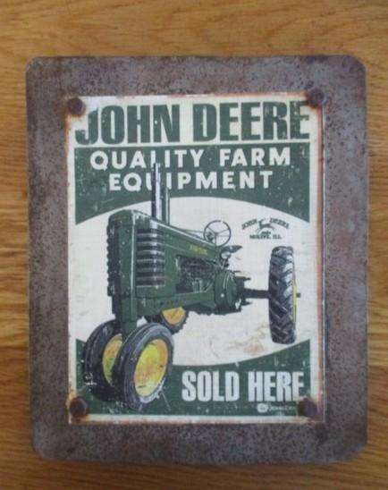 An old vintage John Deere metal sign