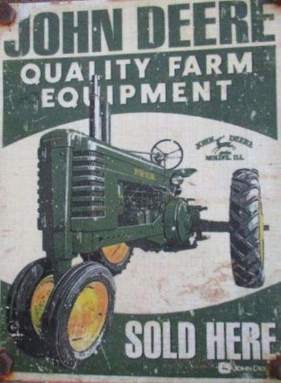 An old vintage John Deere metal sign