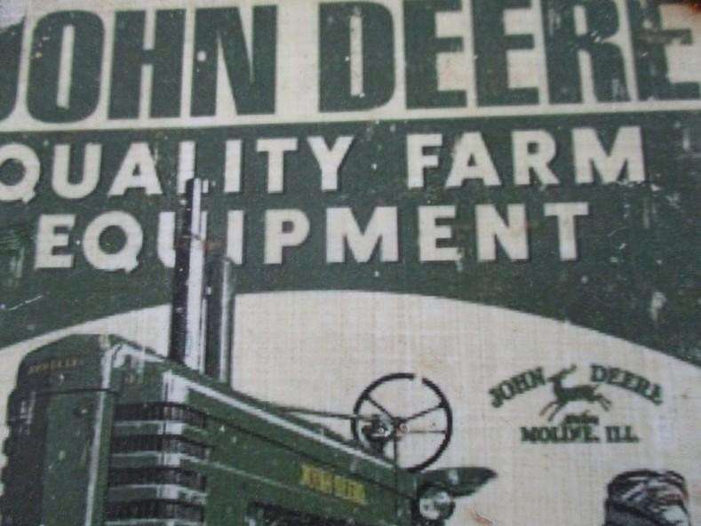 An old vintage John Deere metal sign