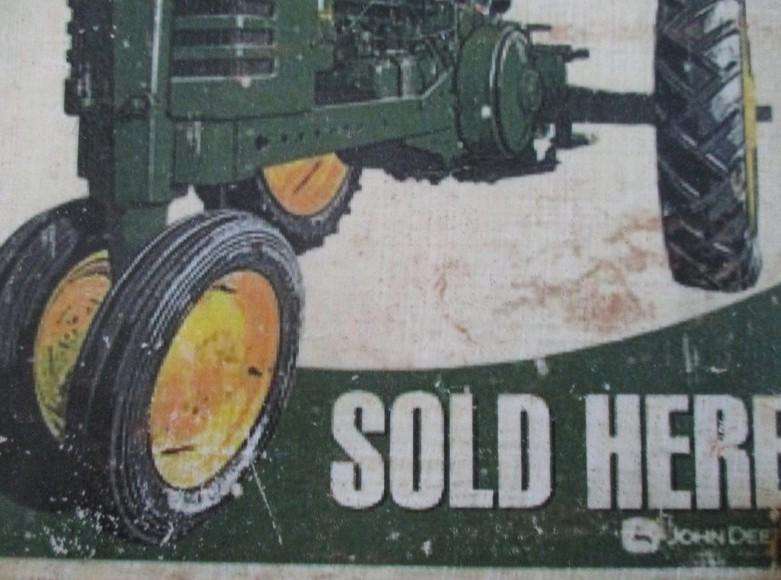 An old vintage John Deere metal sign