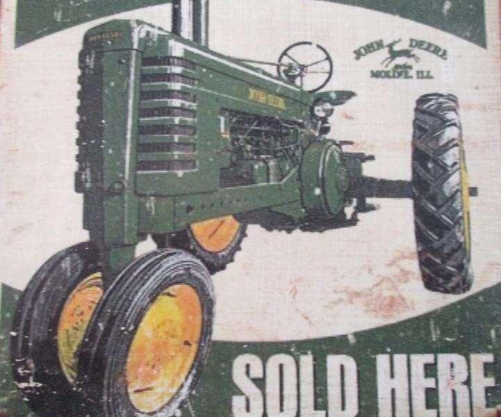An old vintage John Deere metal sign
