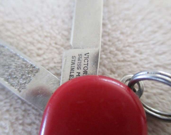 Small vintage Victorinox Swiss Army Knife plus other small fold-up tool gadget