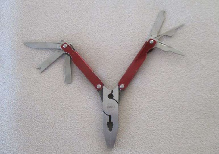 Small vintage Victorinox Swiss Army Knife plus other small fold-up tool gadget