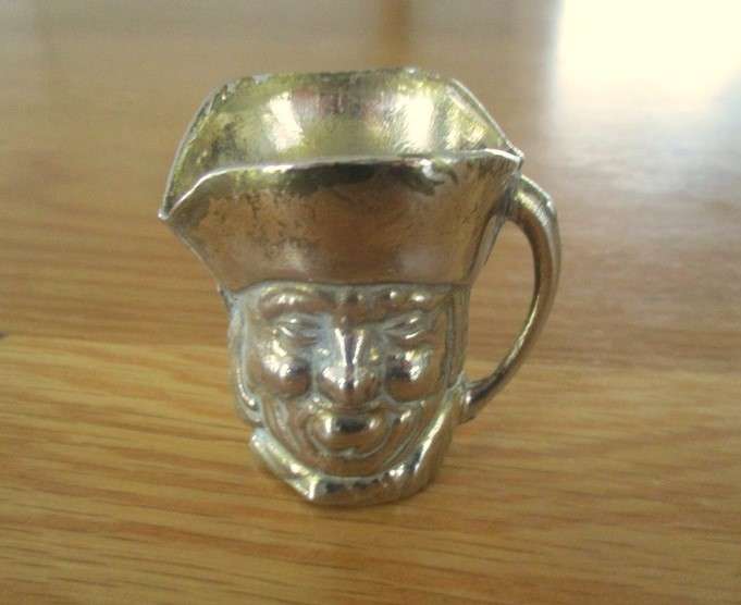 Three cute miniature brass Toby jugs