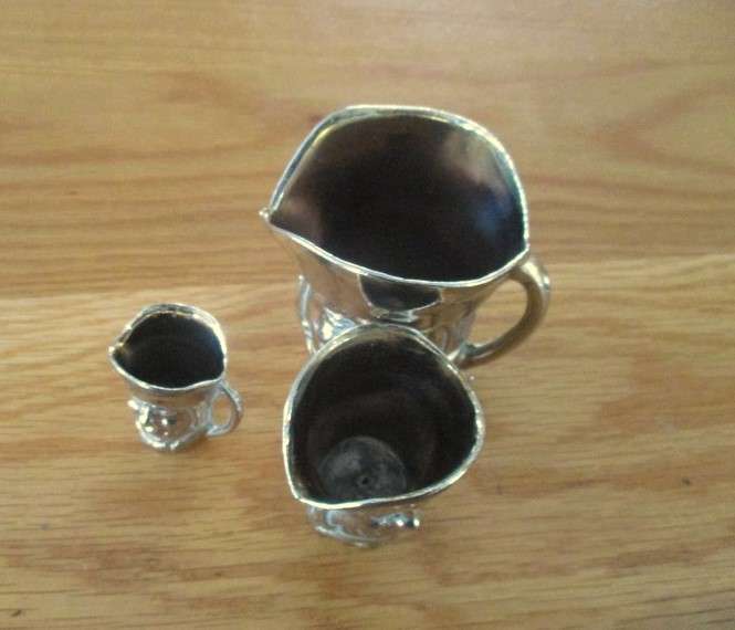 Three cute miniature brass Toby jugs