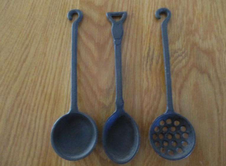 Three vintage solid cast iron ladles