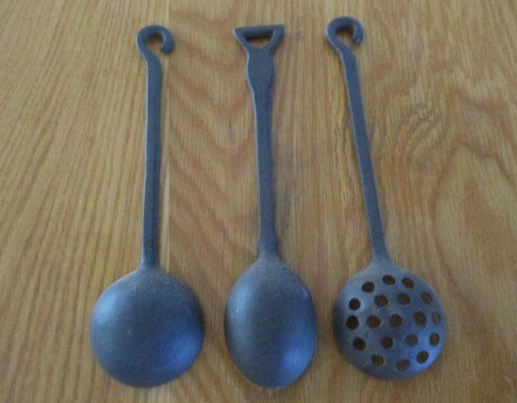 Three vintage solid cast iron ladles
