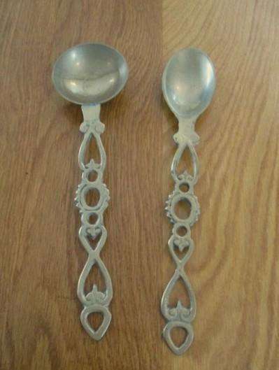 Two ornate Welsh-style solid brass Love Spoons made in India