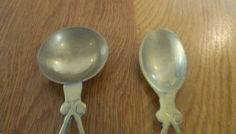Two ornate Welsh-style solid brass Love Spoons made in India