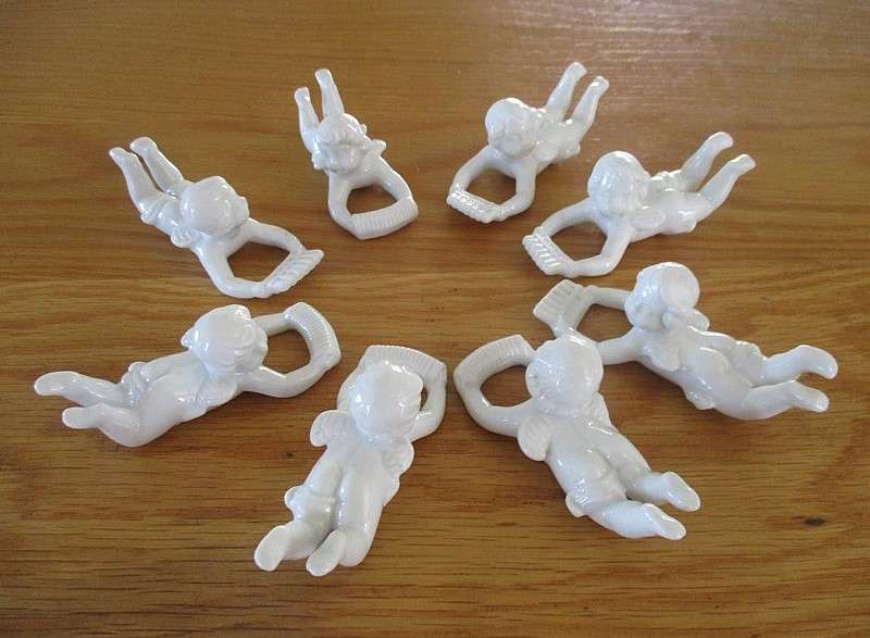 Eight beautiful blanc de chine cherub wall hangers/napkin holders/ornaments