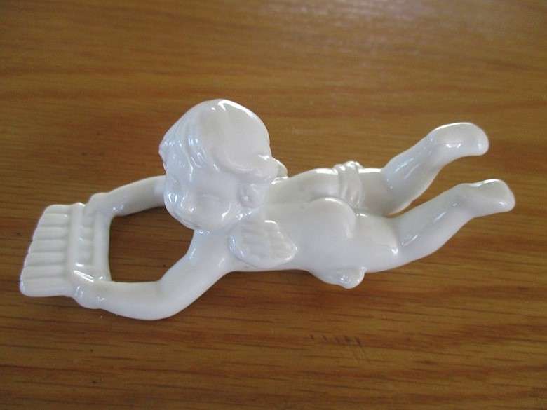 Eight beautiful blanc de chine cherub wall hangers/napkin holders/ornaments
