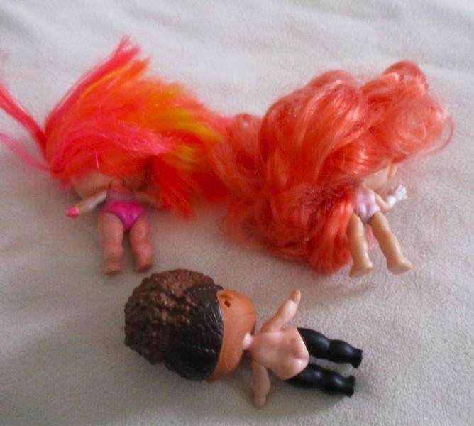 Two adorable small LOL Surprise dollies made by MGA plus one curly-haired friend