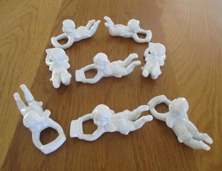 Eight beautiful blanc de chine cherub wall hangers/napkin holders/ornaments