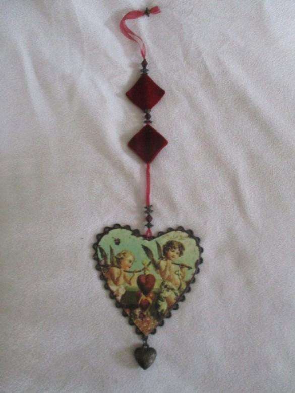 A cute small vintage metal wall/mirror/window hanging heart shaped sign with angels