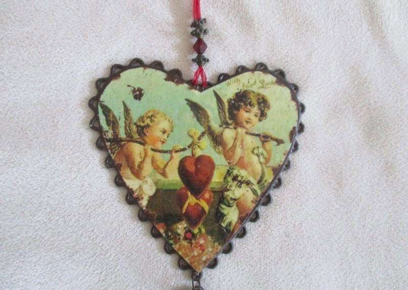 A cute small vintage metal wall/mirror/window hanging heart shaped sign with angels