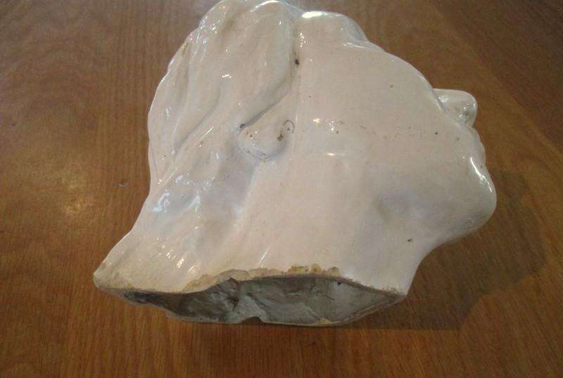 A vintage shabby chic glazed pottery head for inside or outside