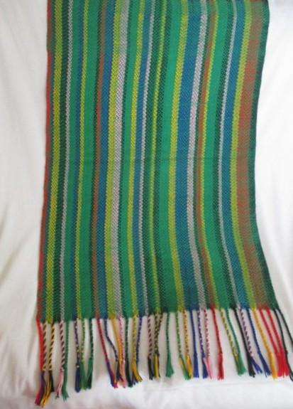 1. A colourful reversable woven throw/shawl - predominantly green
