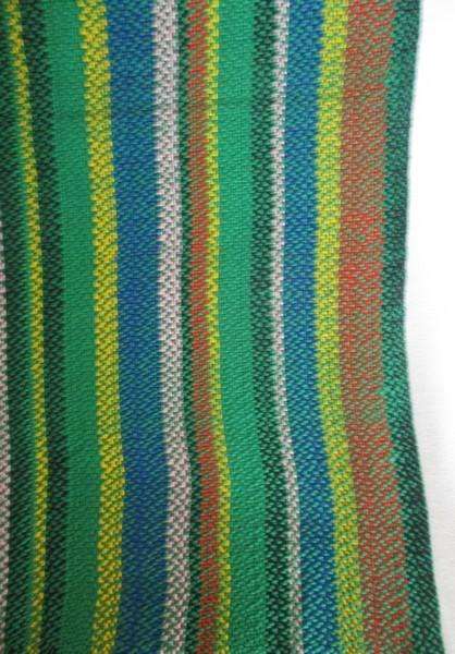 1. A colourful reversable woven throw/shawl - predominantly green