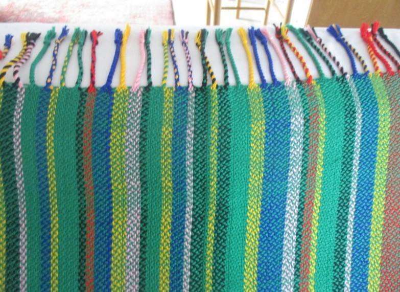 1. A colourful reversable woven throw/shawl - predominantly green