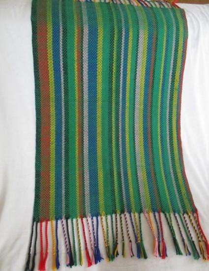 1. A colourful reversable woven throw/shawl - predominantly green