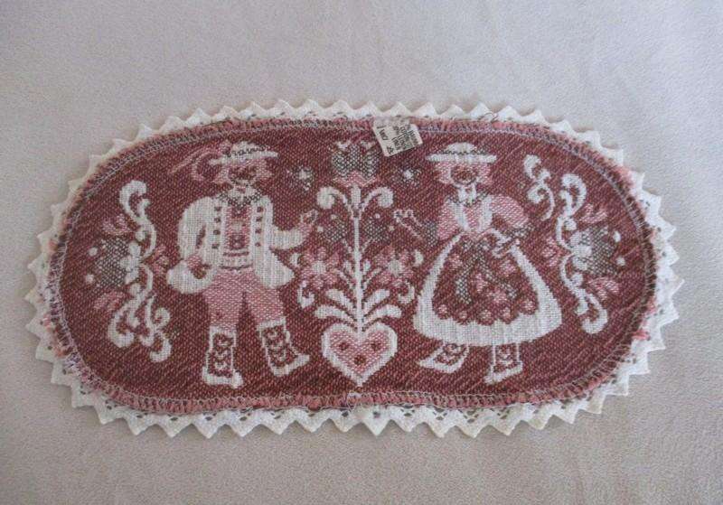 Small woven Austrian cloth with traditional Austrian figures and crocheted border