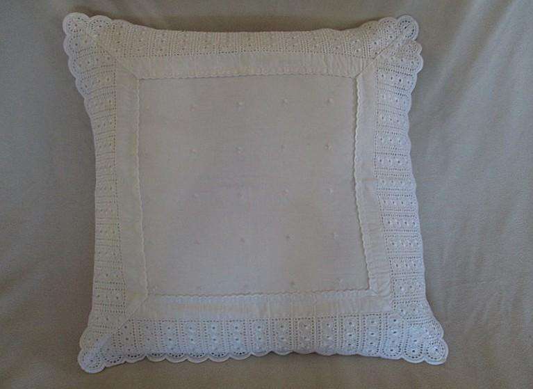 Pretty cushion with wide embroidered lace border