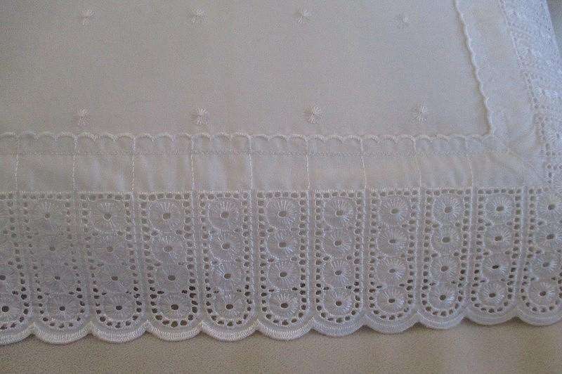 Pretty cushion with wide embroidered lace border