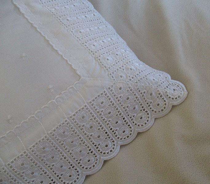 Pretty cushion with wide embroidered lace border