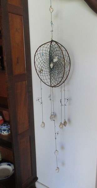 A breezy and decorative seashell and string hanger