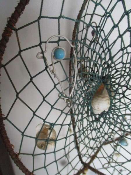 A breezy and decorative seashell and string hanger