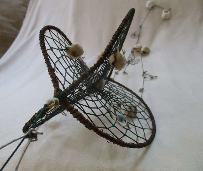 A breezy and decorative seashell and string hanger