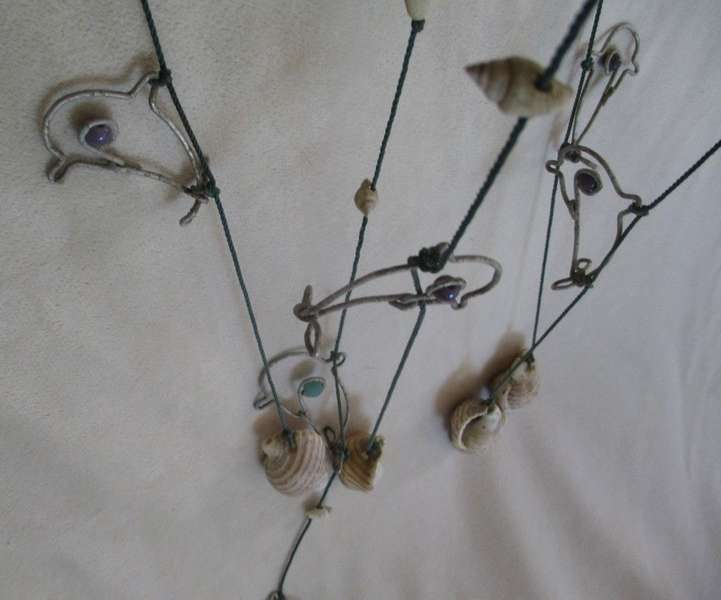 A breezy and decorative seashell and string hanger