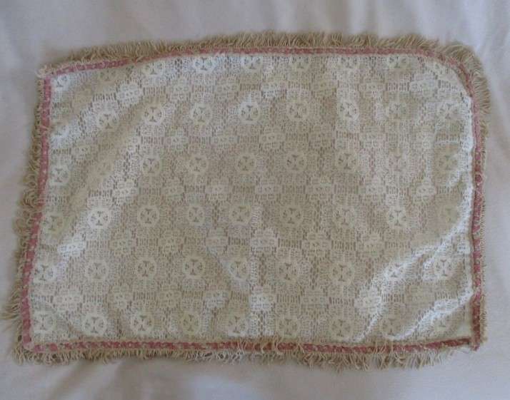A vintage rectangular lace cloth with pretty tassel border