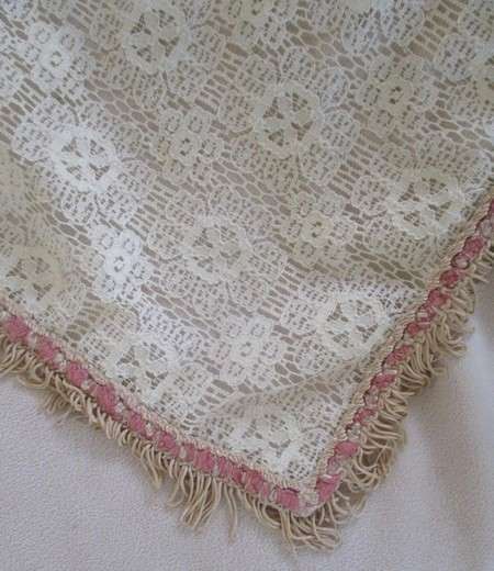 A vintage rectangular lace cloth with pretty tassel border